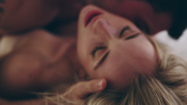 4K video footage of a young couple being intimate in bed at home
