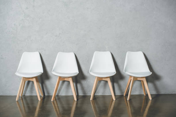 istock white empty chairs for job interview standing in line in hall 823353634