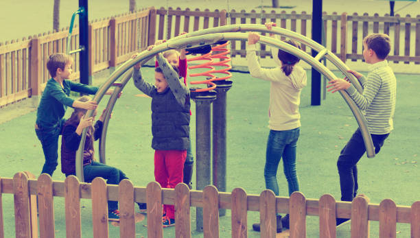 istock Boy in elementary school age riding toy on children's playground 823360670