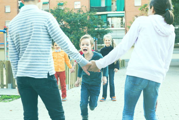 istock Group of children playing red rover 823360714