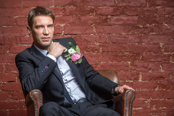 istock serious bridegroom looking and sits 823361098