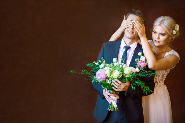 istock bride covered hands the groom's eyes 823361188