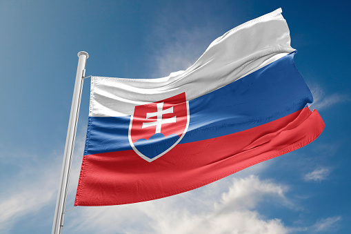 Slovakia flag is waving at a beautiful and peaceful sky in day time while sun is shining. 3D Rendering