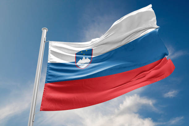 istock Slovenia Flag is Waving Against Blue Sky 823364608