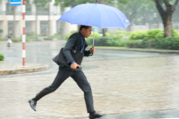 istock Running Businessman Escaping Rain 823365244