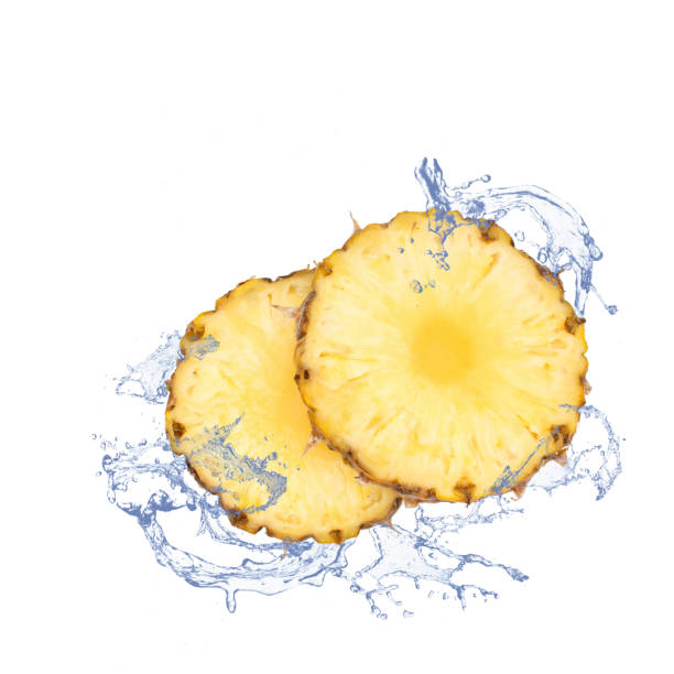 istock Fresh pineapple slices with water splash, isolated on white. 823365268