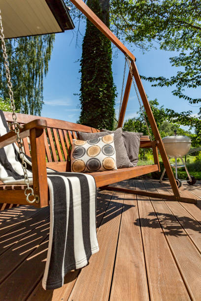 istock Wooden terrace with a garden swing 823369634
