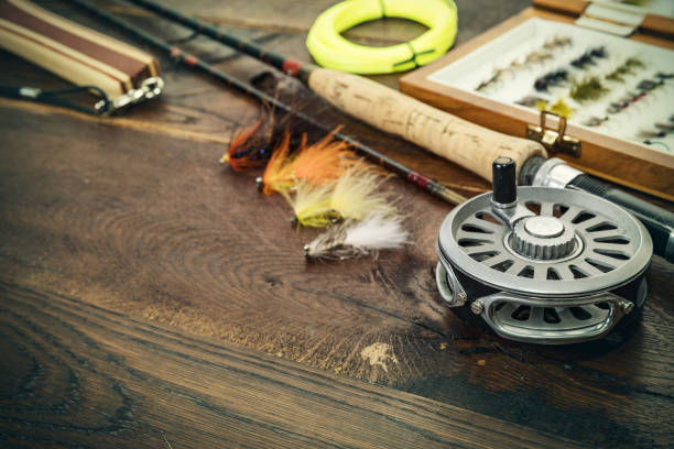 net, fishing rod, set by river Net, fishing rod, set by river for fly fishing on an old wooden table fly fishing stock pictures, royalty-free photos & images
