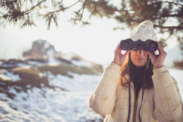istock woman hiker looking into binoculars 823374860