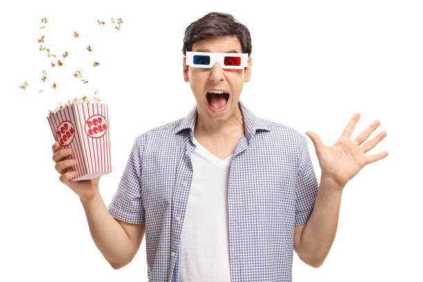 istock Terrified guy with a pair of 3D glasses and popcorn 823375536