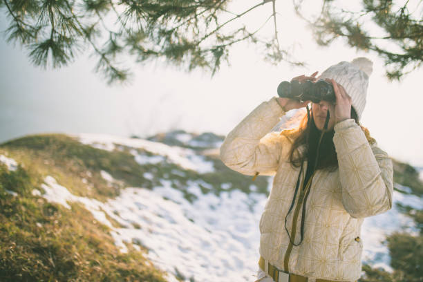 istock woman hiker looking into binoculars 823383242