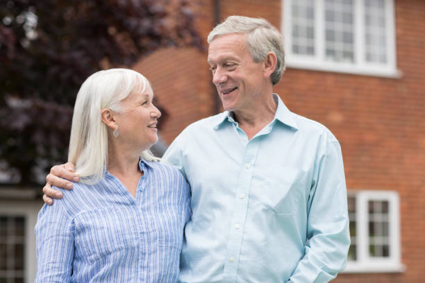 istock Retired Couple Standing Outside Home 823398958