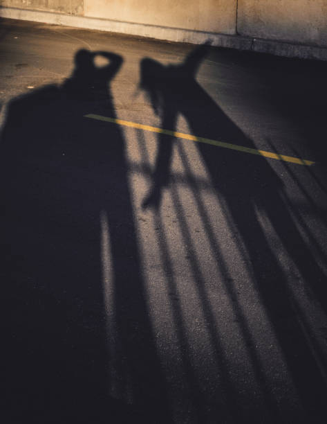 istock Shadows of people standing in a street during sunset 823399302