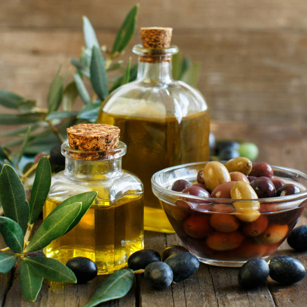 istock Olive oil and olives on  wood background 823417152