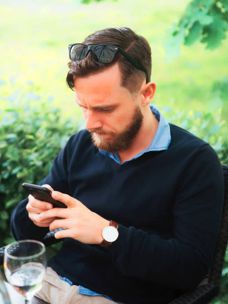 istock Young man looking at his mobile phone 823417386