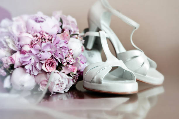 istock Beautiful wedding bouquet and bride's shoes 823417626