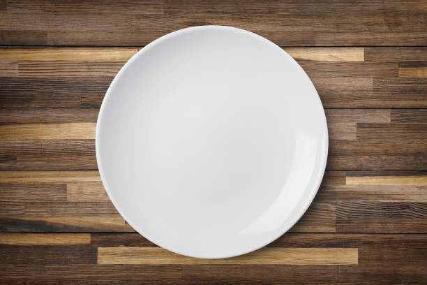 istock Empty plate on old wooden background. Top view 823417966