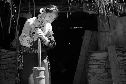 Chinese young women in Tibet make butter tea in old ways.