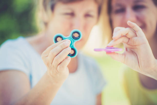 istock Two mature women with  spinner in hands close up 823426134