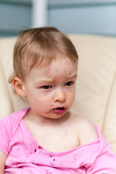 istock 2 years old girl child is eating 823429116