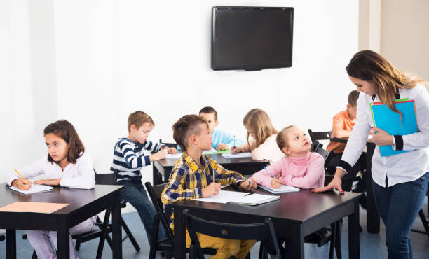 istock Little children with teacher in classroom 823434166