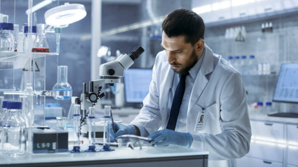 istock Research Scientist Writes Down Observations. He's Conducts Experiments in Modern Laboratory. 823447564