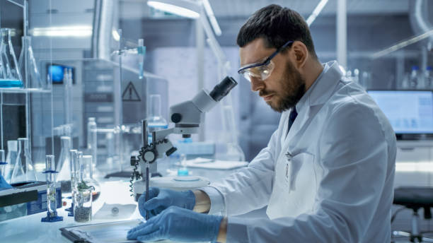 istock In a Modern Laboaratory Research Scientist Writes Down His Experiment Observations. 823447706
