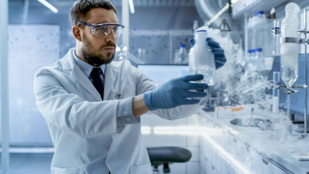 istock In a Chemical Research Laboratory Scientist Holds Smoking Compound in Beaker. 823447720