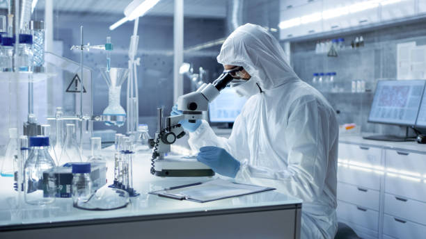 istock In a Secure High Level Research Laboratory Scientist in a Coverall Examines Petri Dish Under Microscope. 823447746