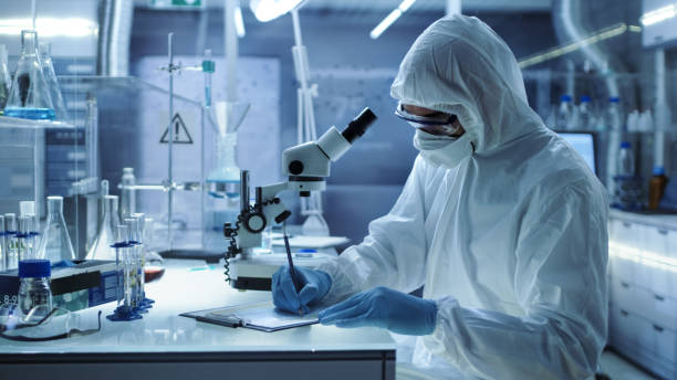 istock In a Secure High Level Research Laboratory Scientist Writing Down Experiment Results. 823447766