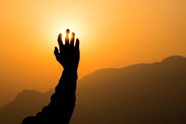 istock Right hand reaching golden sun 823450758