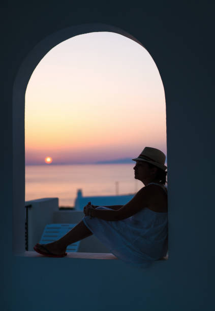 istock Woman at sunset in Santorini 823452234