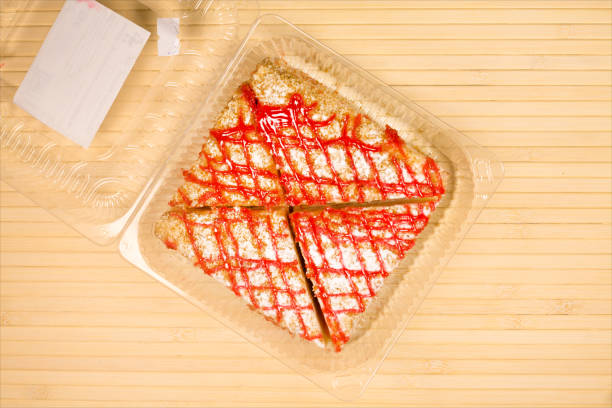 istock Cakes in the transparent plastic box over wooden background 823454854