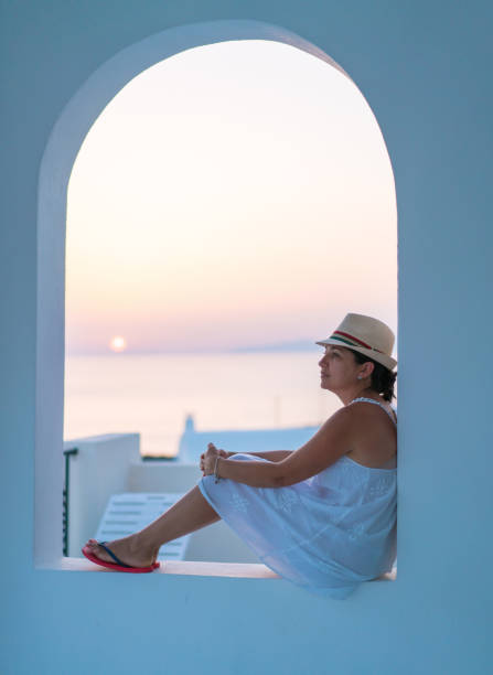 istock Woman at sunset in Santorini 823455774