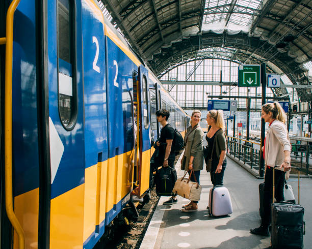 istock Tourists Catching The Train In Amsterdam 823458536