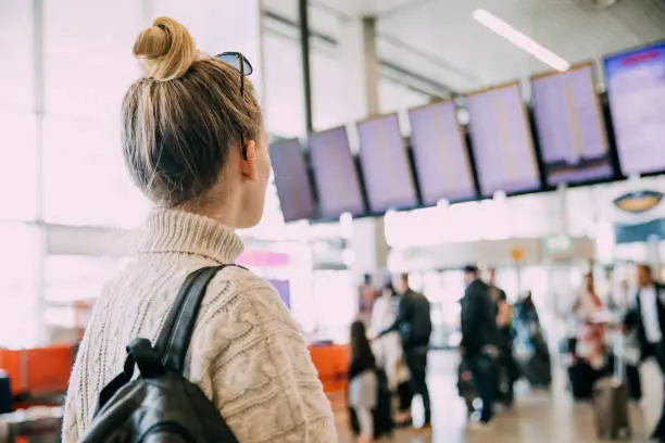 A young woman in Amsterdam waiting at the airport.