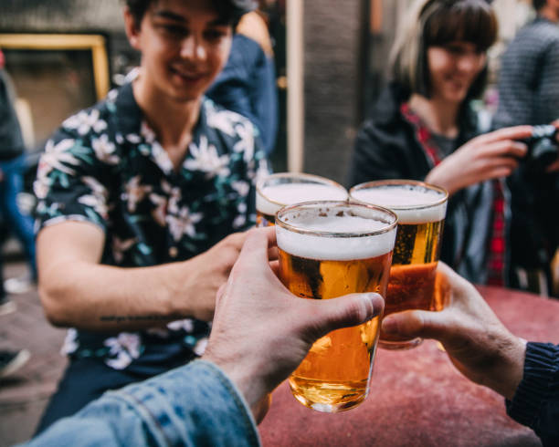 toasting with pints of beer - beer pub women pint glass imagens e fotografias de stock