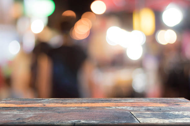 istock Blurred background and old wooden table on font, abstract 823470076