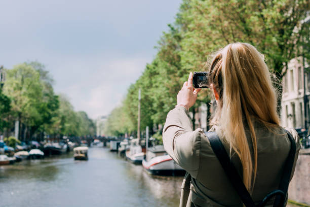 istock Taking a Picture of a Canal in Amsterdam 823471032