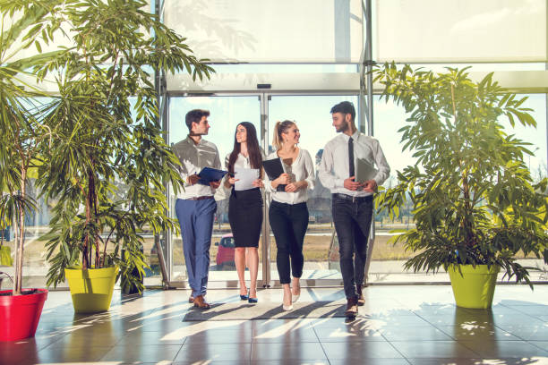 istock Confident business partners walking down in office building and talking about new project. 823488660