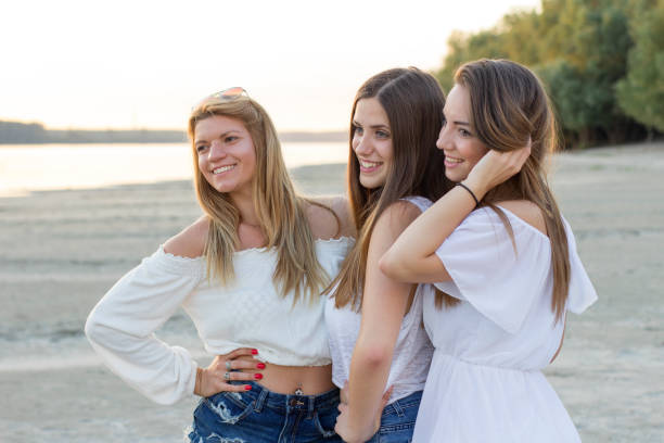 istock Three girls on the beach 823491846