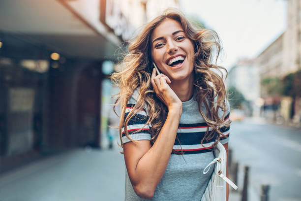 istock Happy young woman with mobile phone 823493230