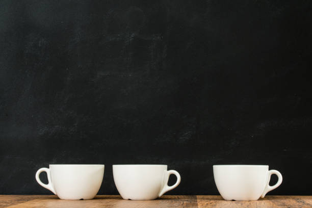 istock ceramic white coffee cups grouped on wooden floor 823505438
