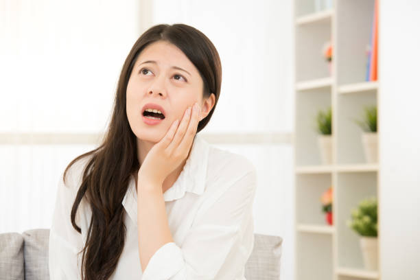 istock Toothache young woman touching her cheek 823506578