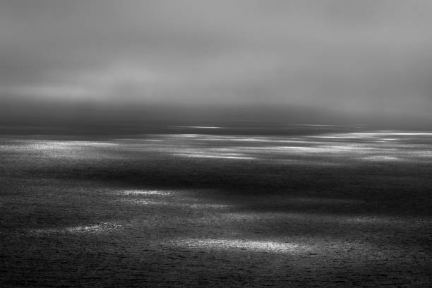 istock Seascape with ethereal sunbeams on the surface. 823515136