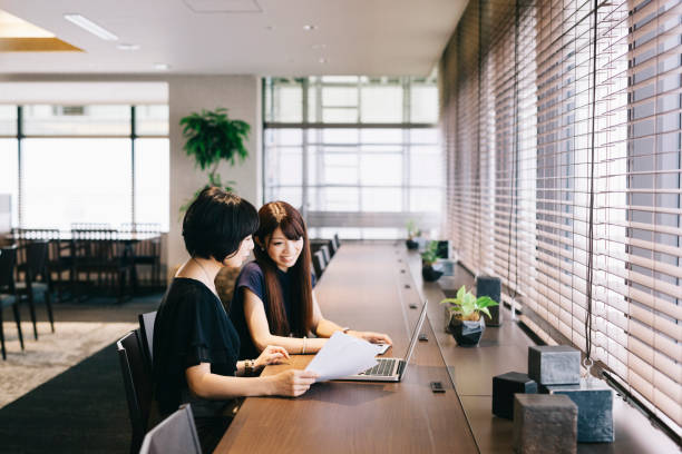 istock Two businesswomen talking in a modern office 823520344