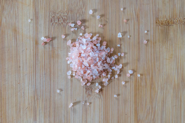 Himalayan Pink Rock Salt on Bamboo Board stock photo