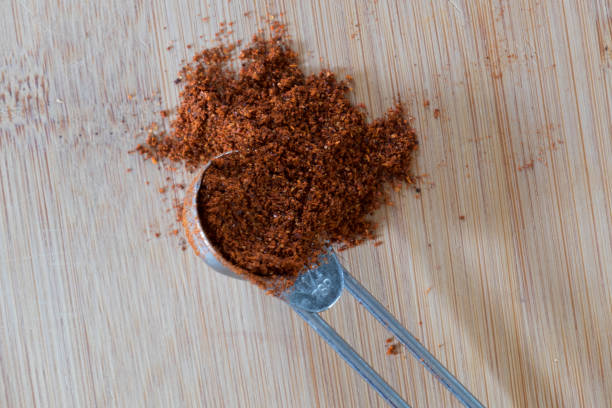 A measuring spoon full of spice stock photo