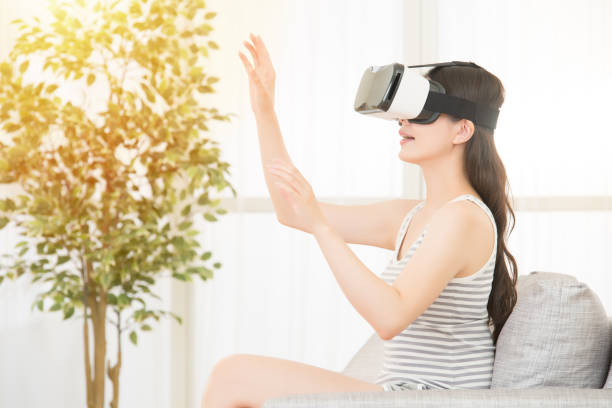 istock woman wearing virtual reality goggles 823524496