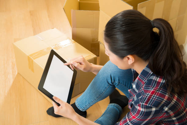 istock female moving new house checking on digital tablet 823528808